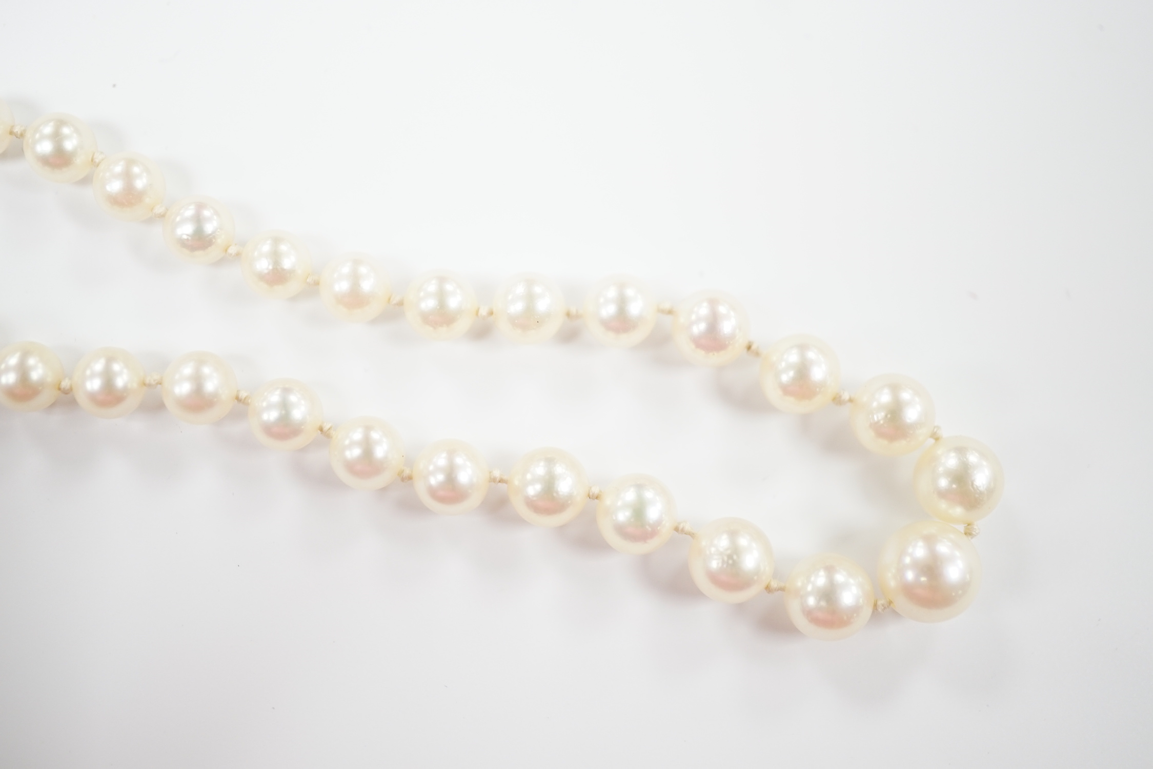 A single strand graduated cultured pearl necklace, with single stone diamond chip set 9ct white metal clasp, 46cm.